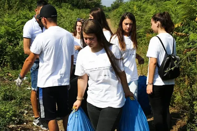 Young volunteers collecting waste outdoors