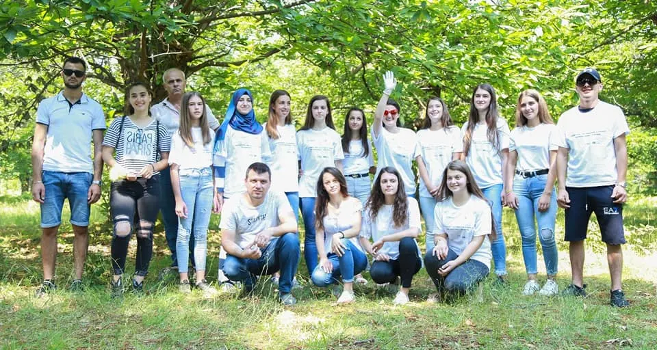 RiD group photo with young people in white T-shirts outdoors
